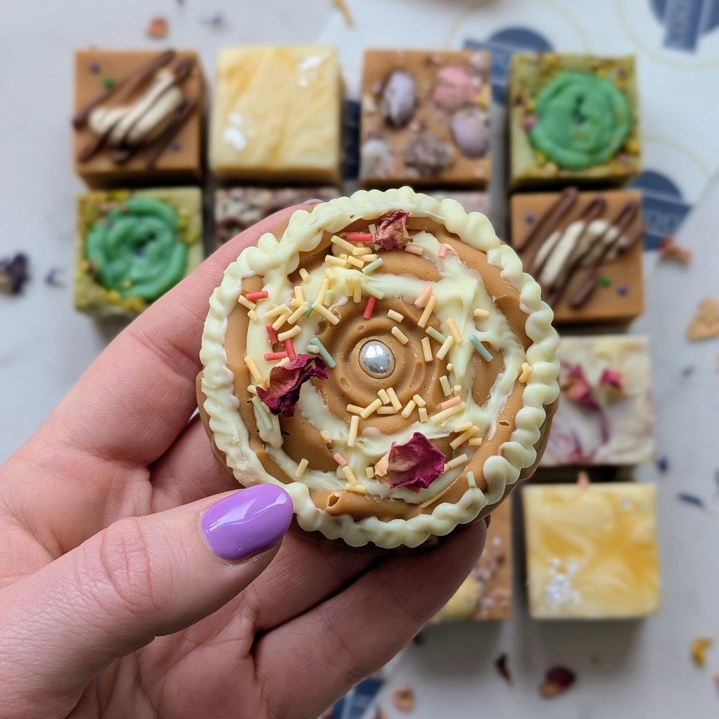 Decorated fudge tart with rose petals and gold drizzle